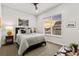 Bedroom with ceiling fan, light gray bedding, and a view to the garage at 9388 Dunraven Loop, Arvada, CO 80007