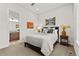 Bedroom with neutral tones, bathroom access, and modern decor at 9388 Dunraven Loop, Arvada, CO 80007