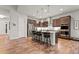 Modern kitchen with stainless steel appliances, dark wood cabinets, and a central island with seating at 9388 Dunraven Loop, Arvada, CO 80007