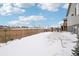 Large backyard with a wooden fence and snow-covered ground at 7916 S Grand Baker Way, Aurora, CO 80016