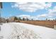 Large backyard with a wooden fence and snow-covered ground at 7916 S Grand Baker Way, Aurora, CO 80016