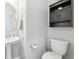 Clean bathroom with pedestal sink and dark wood cabinet at 7916 S Grand Baker Way, Aurora, CO 80016