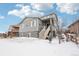 Two-story house with gray siding and stone accents, winter view at 7916 S Grand Baker Way, Aurora, CO 80016