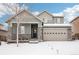 Two-story house with gray siding, stone accents, and a three-car garage at 7916 S Grand Baker Way, Aurora, CO 80016