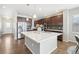 Modern kitchen with island, stainless steel appliances, and dark cabinets at 7916 S Grand Baker Way, Aurora, CO 80016