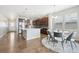 Modern kitchen with island, stainless steel appliances, and dark cabinets at 7916 S Grand Baker Way, Aurora, CO 80016