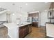 Modern kitchen with island, stainless steel appliances, and dark cabinets at 7916 S Grand Baker Way, Aurora, CO 80016