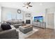 Spacious living room with L-shaped sofa, fireplace, and large windows at 7916 S Grand Baker Way, Aurora, CO 80016