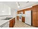 Kitchen featuring white appliances and wooden cabinets at 5714 N Gibralter Way # 5-306, Aurora, CO 80019