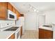 Spacious kitchen featuring white appliances and wooden cabinets at 5714 N Gibralter Way # 5-306, Aurora, CO 80019