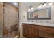 The bathroom features stylish stone tile on walls and pebble tile flooring in the walk-in shower at 13012 S Wamblee Valley Rd, Conifer, CO 80433