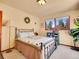 Bright bedroom with natural light, comfortable bed, and pleasant views of the outdoors at 13012 S Wamblee Valley Rd, Conifer, CO 80433