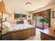 Comfortable bedroom with natural light, cozy bedding, and backyard access at 13012 S Wamblee Valley Rd, Conifer, CO 80433