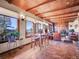 Open-concept living area with a wood ceiling, stone fireplace, and mountain views at 13012 S Wamblee Valley Rd, Conifer, CO 80433