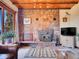 Living room stone fireplace with wood-burning stove and custom stonework at 13012 S Wamblee Valley Rd, Conifer, CO 80433