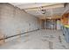 Unfinished garage featuring a concrete floor, cinder block walls, and wooden framing at 13012 S Wamblee Valley Rd, Conifer, CO 80433