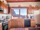Well-lit kitchen with wood cabinets, marble countertops, and stainless steel appliances at 13012 S Wamblee Valley Rd, Conifer, CO 80433