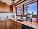 Kitchen features granite counters, wood cabinets, stainless steel appliances, and a view at 13012 S Wamblee Valley Rd, Conifer, CO 80433