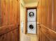 Convenient laundry area with a stacked washer and dryer, and custom wood door at 13012 S Wamblee Valley Rd, Conifer, CO 80433