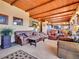 This living room features a wood-beamed ceiling, comfortable seating, and open floor plan at 13012 S Wamblee Valley Rd, Conifer, CO 80433