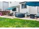 A backyard patio boasts a hot tub, lounge furniture, and manicured green grass at 9677 Castle Ridge Cir, Highlands Ranch, CO 80129