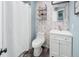 Charming bathroom features floral wallpaper, wood-look flooring, and stylish vanity at 9677 Castle Ridge Cir, Highlands Ranch, CO 80129
