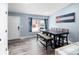 Bright dining area with a large window, modern table with bench, and views of the front yard at 9677 Castle Ridge Cir, Highlands Ranch, CO 80129
