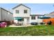 The spacious backyard features a well-maintained lawn, patio, and stylish two-story house at 9677 Castle Ridge Cir, Highlands Ranch, CO 80129
