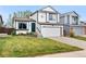 Charming two-story home features a well-manicured lawn, two-car garage, and inviting front entrance at 9677 Castle Ridge Cir, Highlands Ranch, CO 80129