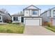 Charming two-story home features a well-manicured lawn, two-car garage, and inviting front entrance at 9677 Castle Ridge Cir, Highlands Ranch, CO 80129
