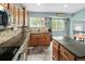 Bright kitchen features beautiful wood cabinets, stainless steel appliances, and an island with countertop at 9677 Castle Ridge Cir, Highlands Ranch, CO 80129