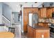 Open-concept living room flows seamlessly into the kitchen with access to the staircase at 9677 Castle Ridge Cir, Highlands Ranch, CO 80129