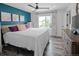 Comfortable main bedroom featuring bright window, dark accent wall, and wooden dresser at 9677 Castle Ridge Cir, Highlands Ranch, CO 80129