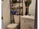 Small bathroom with toilet, sink, and shelving unit at 1227 S Uvalda St, Aurora, CO 80012