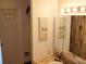 Bathroom features a vanity with a mirror and decorative art at 1227 S Uvalda St, Aurora, CO 80012