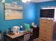 Bedroom with blue walls, dresser, and ocean-themed art at 1227 S Uvalda St, Aurora, CO 80012