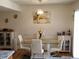 Dining area with glass table and white chairs at 1227 S Uvalda St, Aurora, CO 80012