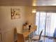 Bright dining room with glass table and white chairs, featuring a modern chandelier at 1227 S Uvalda St, Aurora, CO 80012