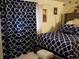 Main bedroom with navy and white bedding and a large window at 1227 S Uvalda St, Aurora, CO 80012