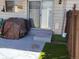 Small patio area with concrete flooring and artificial turf at 1227 S Uvalda St, Aurora, CO 80012