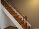 Wood staircase with simple design and neutral color palette at 1227 S Uvalda St, Aurora, CO 80012