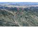 An aerial view pinpoints 79 Beaver Rd in a mountainous region with views of Downtown Idaho Springs at 79 Beaver Rd, Idaho Springs, CO 80452