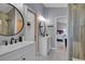 Bright bathroom featuring double vanity sinks and a view into an adjacent bedroom at 79 Beaver Rd, Idaho Springs, CO 80452
