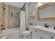 Bathroom featuring a tiled shower and tub, light wood floors, and a white vanity sink at 79 Beaver Rd, Idaho Springs, CO 80452