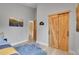 Bedroom with wooden sliding doors, a decorative wall hanging, and light wood floors at 79 Beaver Rd, Idaho Springs, CO 80452