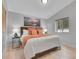 Bedroom with a bed with lots of pillows, light wood floors, and a picture of a mountain at 79 Beaver Rd, Idaho Springs, CO 80452