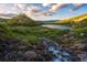 Scenic view of a mountain lake with lush greenery and a flowing stream in the foreground at 79 Beaver Rd, Idaho Springs, CO 80452