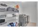 Organized laundry room with shelving and modern washer and dryer units at 79 Beaver Rd, Idaho Springs, CO 80452