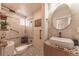 Modern bathroom with a vessel sink, stylish mirror, glass enclosed shower with seating, and unique floor tiles at 537 N Logan St, Denver, CO 80203