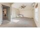 Bright bedroom with neutral walls, carpet, ceiling fan, and a bench under the window at 537 N Logan St, Denver, CO 80203